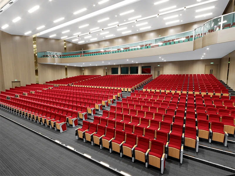 Auditorium chair with foldable writing tablet for lecture hall and exam room use.