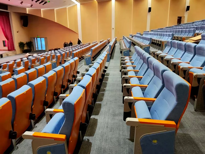 Auditorium chair with foldable writing tablet for lecture hall and exam room use.