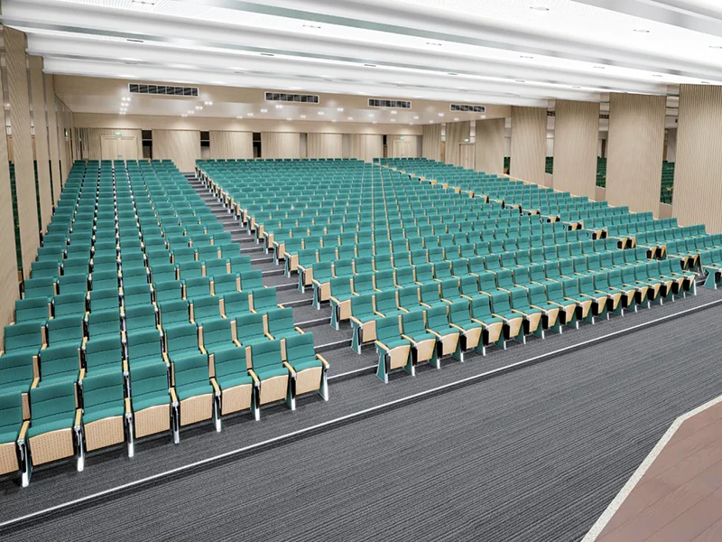 Complete auditorium seating chair with gravity lift for maintenance access.