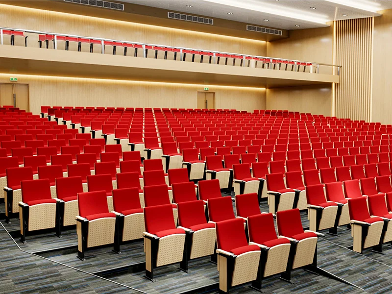 Auditorium chair with foldable writing tablet for lecture hall and exam room use.