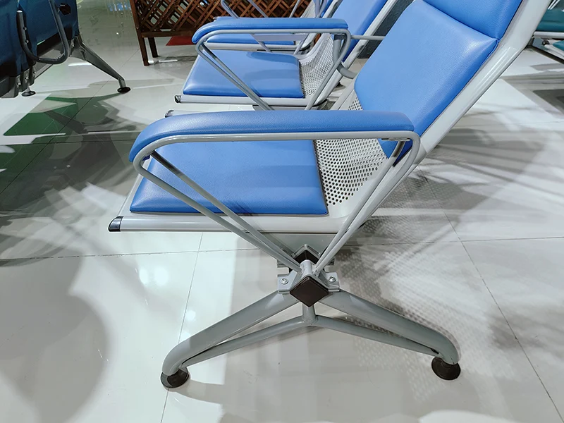 hospital chair with iv pole placed in outpatient clinic setting ready for intravenous medication delivery.