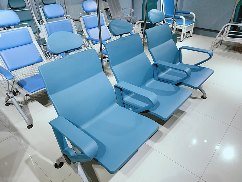 side view of infusion chair in fully reclined position for patient rest during extended treatment sessions.